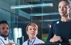 Woman on treadmill with two people watching her vitals